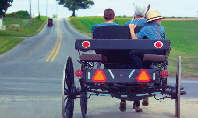 Amish people in an open buggy Amish people in an open buggy