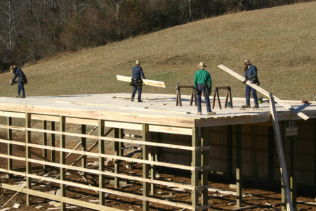 Some humble Amish folk building a barn.