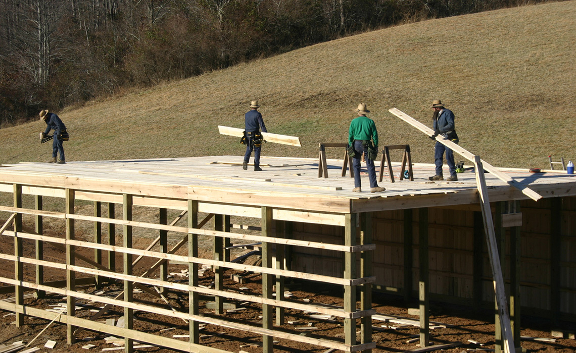 Some humble Amish folk building a barn.