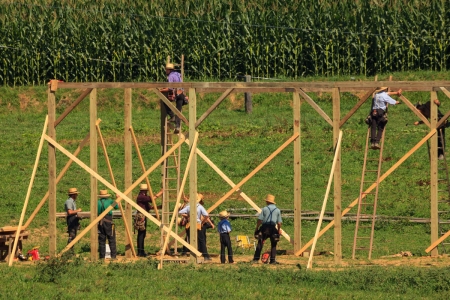New Providence, PA, USA - July 30, 2013: Amish farmers at a “barn raising” in rural Lancaster County.