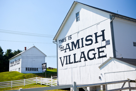 A picture of signage painted on a barn at The Amish Village