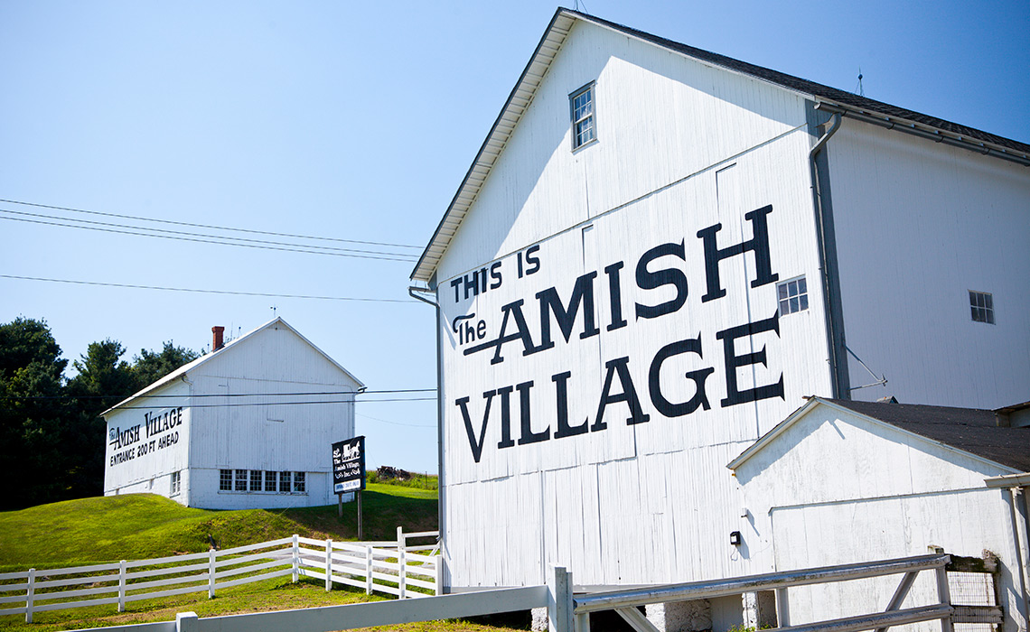 A picture of signage painted on a barn at The Amish Village