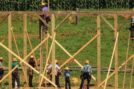 New Providence, PA, USA - July 30, 2013: Amish farmers at a “barn raising” in rural Lancaster County.